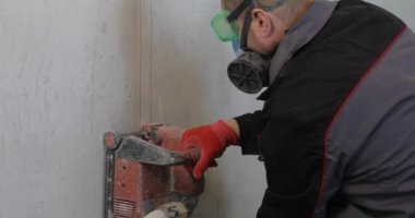 Elektrikçi tel kanalı dairesel testere ile kesiyor..