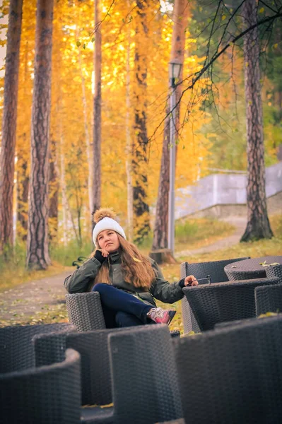 Young Girl Long Hair Sits Chair Autumn Park — Zdjęcie stockowe