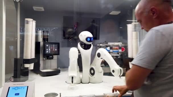 Chelyabinsk, Russia, May 17, 2021. A robot at an airport kiosk serves a customer. Puts out ice cream — Stock Video