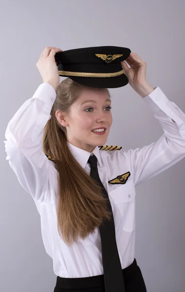 Young female airline pilot in uniform