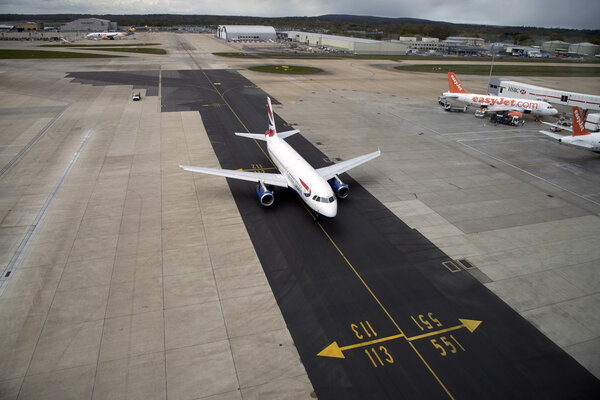 Passenger jet using new tarmac taxiway at London Gatwick Airport UK