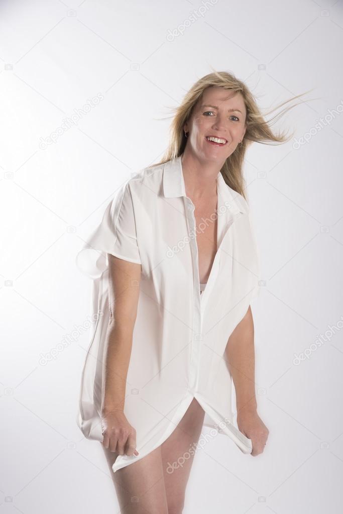 Woman in a white shirt caught in a breeze