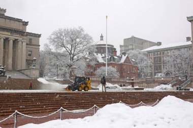  Manhattan, New York, ABD. Şubat 2021. Paten fırçalı traktör New York 'taki Columbia Üniversitesi kampüs bölgesindeki geçitlerden kar temizliyor..                          