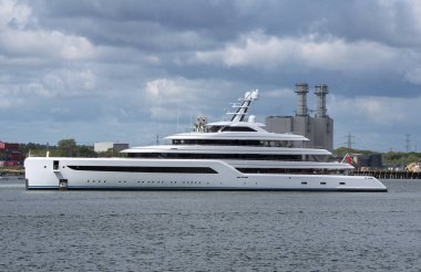 Southampton, England, UK. 18.05.2021.  Super yacht, Dilbar 15,917 tonnes, owned by Russian billionare Alisher Usmanov passing the ERF, Marchwood Energy Recovery Facility in the Port of Southampton, England, UK clipart