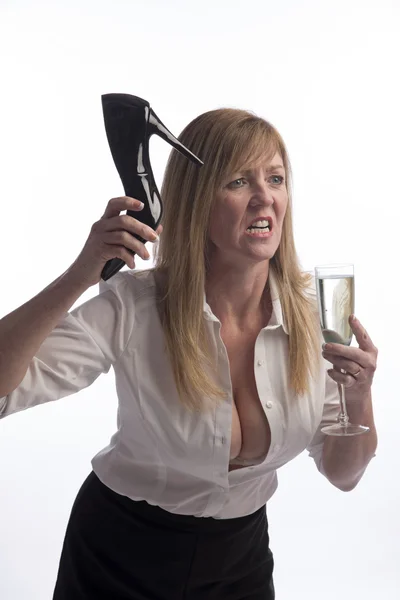 Angry woman holding a high heel shoe — Stock Photo, Image