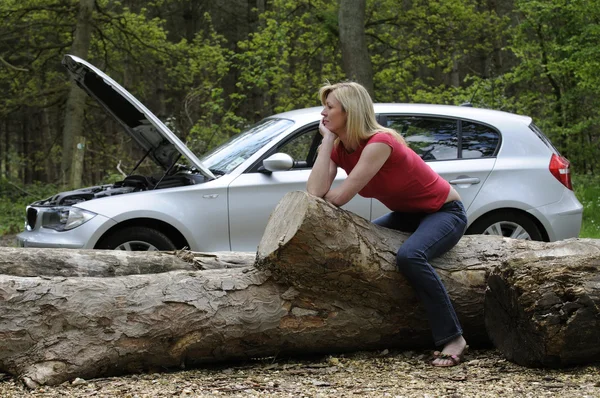 Vrouw met afgebroken auto nemen een rust tijdens het wachten voor een monteur — Stockfoto