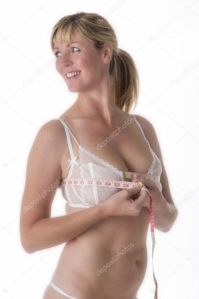 Woman in underwear holding a tape measure