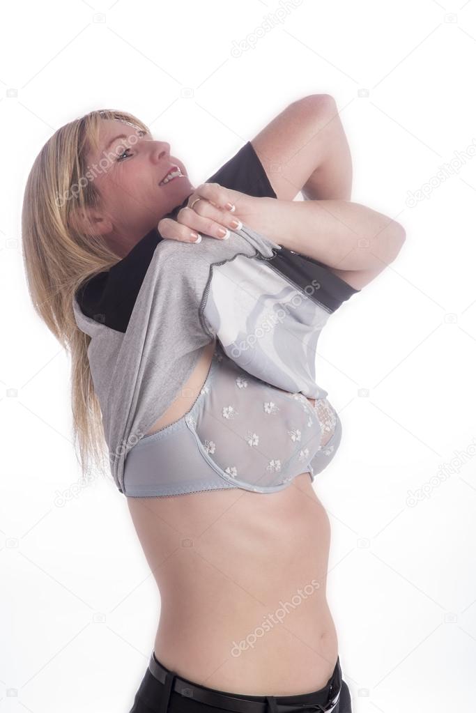 Woman removing her sweater to reveal her bra
