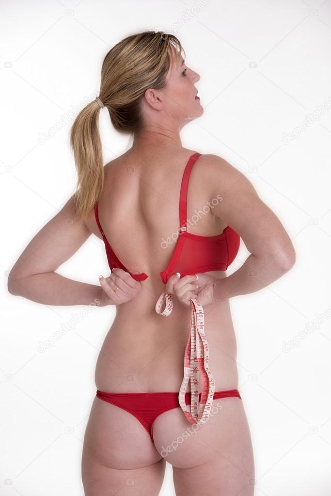 Woman wearing red underwear holding a tape measure Stock Photo by ©petertt  96575050