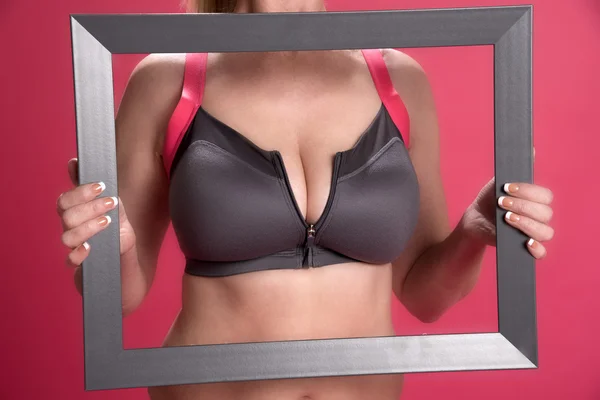 Unzipped sports bra in a picture frame Stock Picture