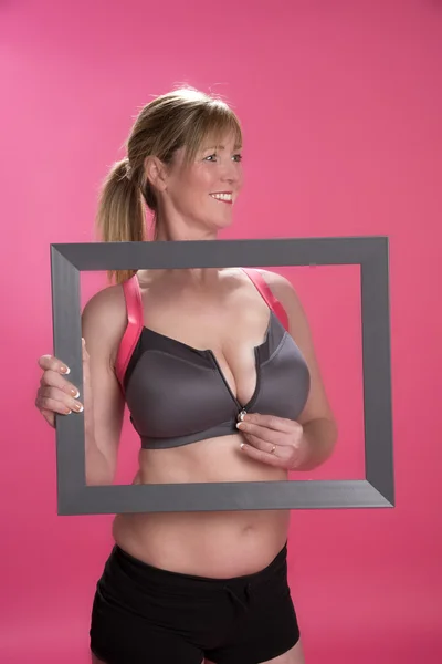 Woman in underwear holding picture frame Stock Image