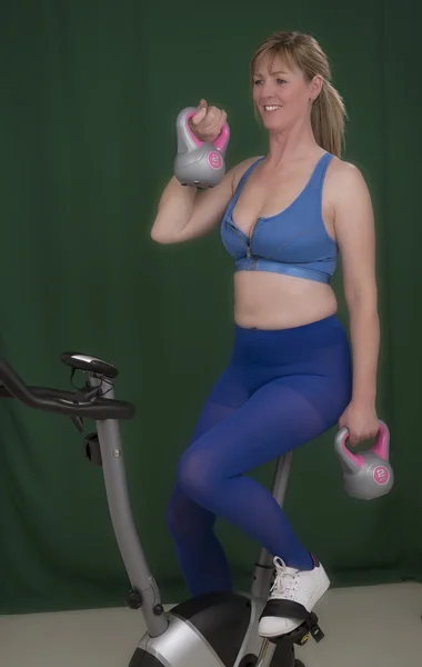 Женщина, использующая колокол чайника для упражнений — стоковое фото