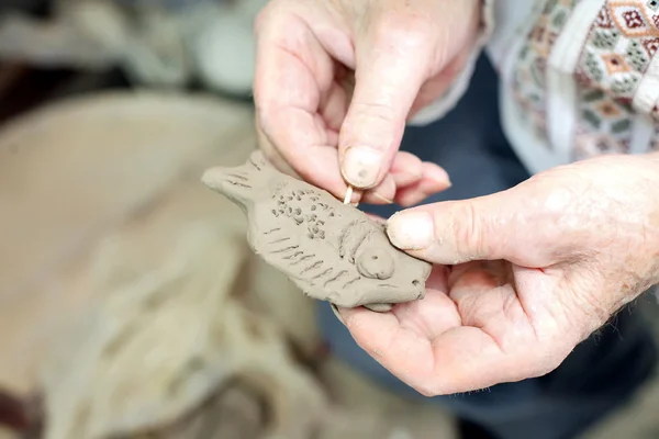 De l'argile à modeler. L'homme sculpte à partir d'argile. Le sifflet des mains d'argile — Photo