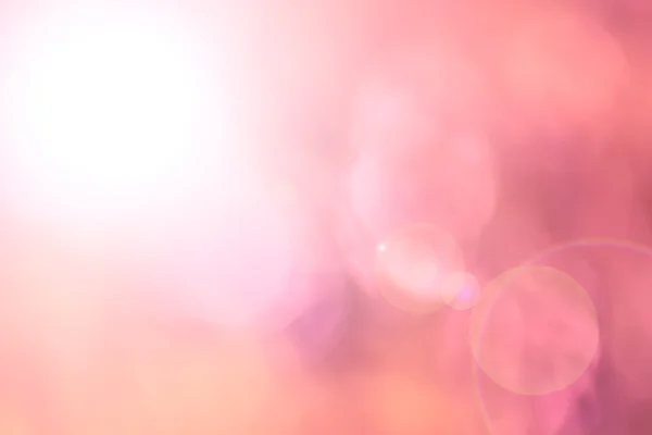 Roze bloem vervagen als achtergrond met lens flare Stockfoto