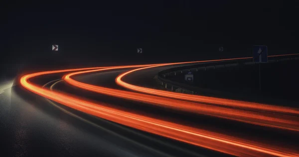 Light traces on road at night and in the fog — Stock Photo, Image