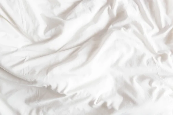 Top view of the crease of an unmade bed sheet in the bedroom. — Stock Photo, Image