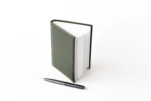 A notepad and a roller pen — Stock Photo, Image