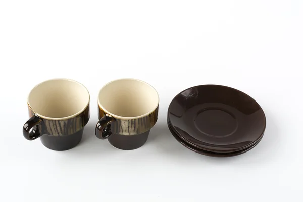 Two ceramic cups with dishes on white background