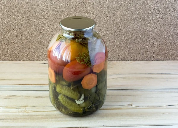 Canned tomatoes and cucumbers in a glass jar — Stock Photo, Image