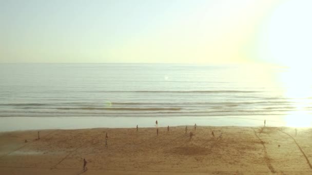 Silhouette of people on the beach of Atlantic ocean slow motion, people playing Football on Beach at Sunset, Morocco, 4k — Stock Video