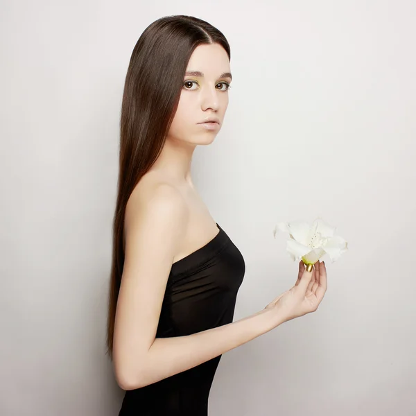 Beautiful young woman with flower — Stock Photo, Image