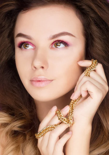 Young beautyful brunette woman with gold — Stock Photo, Image