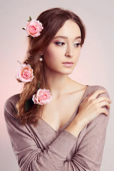 Young woman with flowers in hairs — Stock Photo, Image