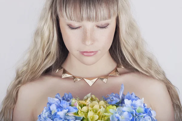 花を持つ美しい金髪の若い女性 — ストック写真