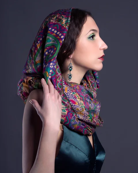 Beautiful young brunette woman in scarf — Stock Photo, Image