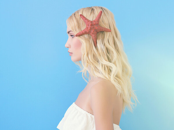 beautiful blond girl with starfish