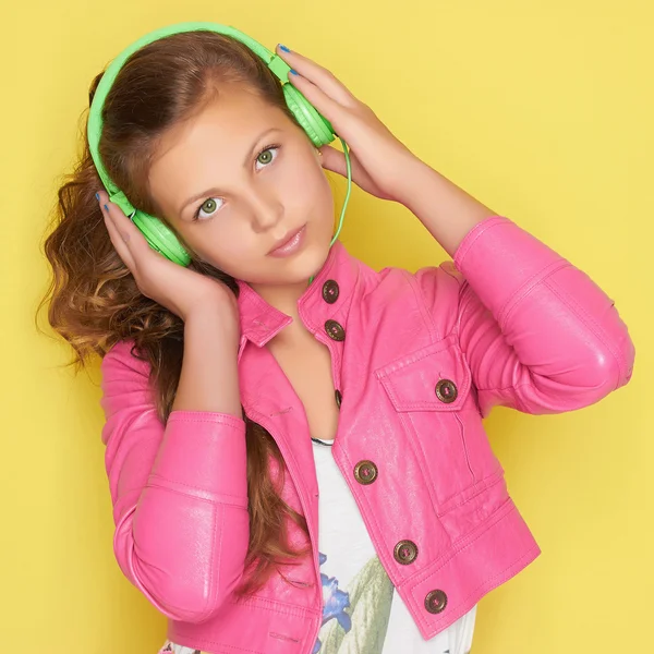 Giovanissima ragazza in rosa ascolto musica — Foto Stock