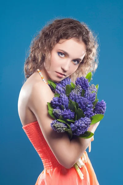 Schöne junge Frau mit Blumen — Stockfoto