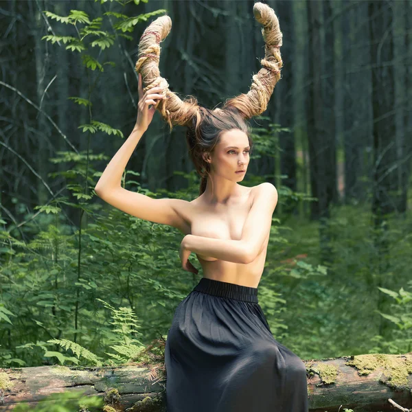 Fantasy girl with horns in woods — Stock Photo, Image