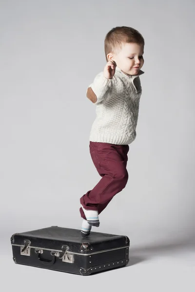 Jumping child with suitcases — Stock Photo, Image