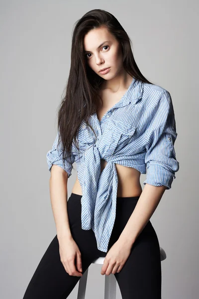 Beautiful model girl sitting on a stool — Stock Photo, Image