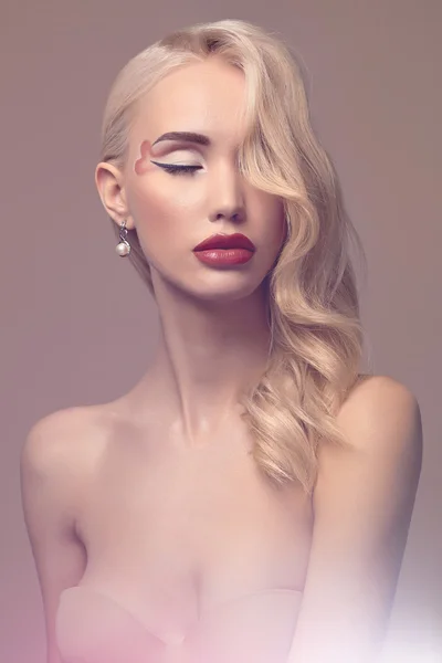 Beautiful blond young woman with make-up — Stock Photo, Image