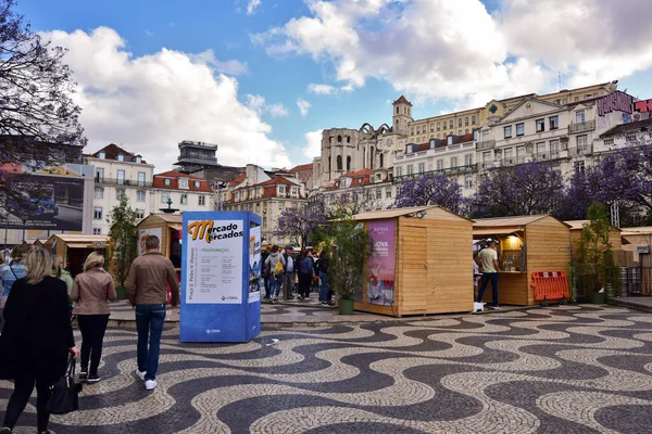Lisbon, Portugal - 05-17-2019 - People walking in Rossio Square in Lisbon during the celebration of an important market