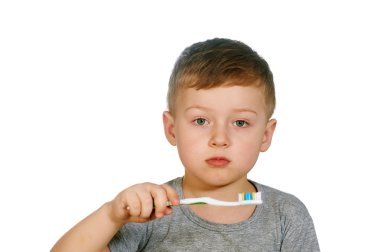 Çatık beyaz arka plan üzerinde izole küçük çocuk diş fırçalamaya memnun