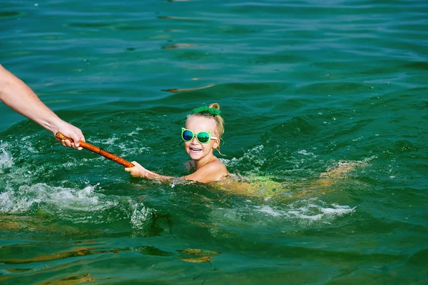 Chica jugando en el mar, aprendiendo a nadar — Foto de Stock