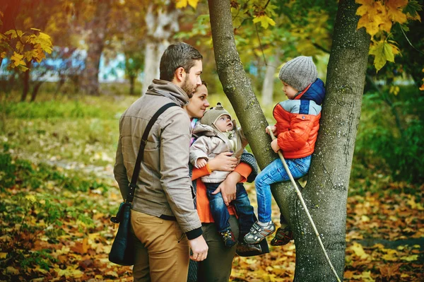 Young happy family walking in autumn Park — Stock Photo, Image