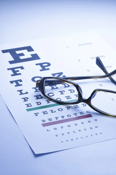 Spectacles with eye chart, blue tone — Stock Photo, Image