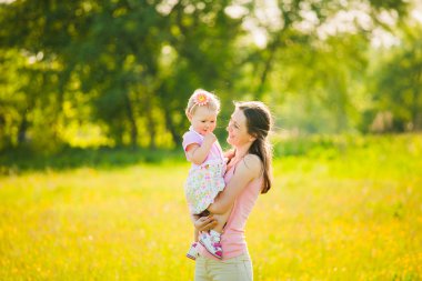 Anne çocuğunu ile güneşli sıcak günde oynarken
