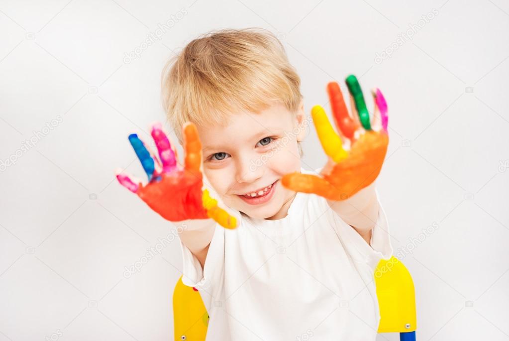 little boy hands painted in colorful paints