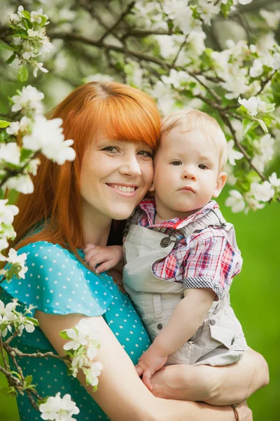 Porträt einer glücklichen Mutter und ihres Sohnes im Frühlingsgarten — Stockfoto