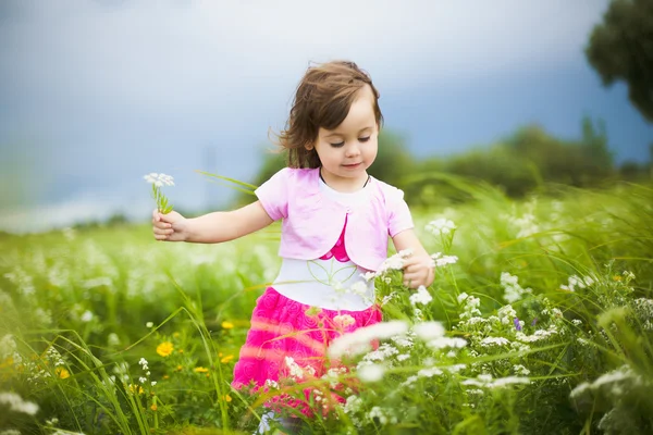 Beautiful carefree girl playing outdoors in field — Stock Photo, Image