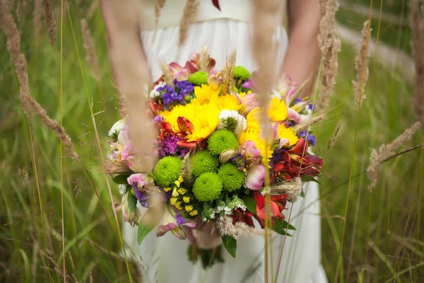 Young bride with bouquet of flowers in her hands