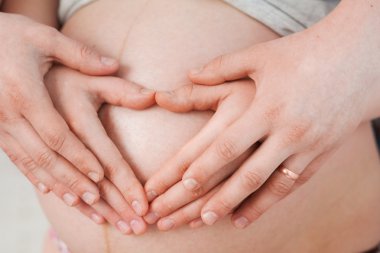 Happy pregnant couple hugging