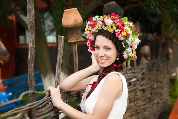 Portrait of young woman with flower wreath in hair — Stock Photo, Image