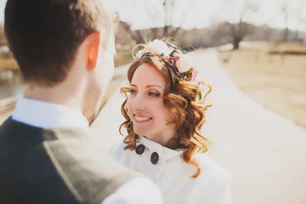 Happy bride and happy groom having walk in park — Stock Photo, Image