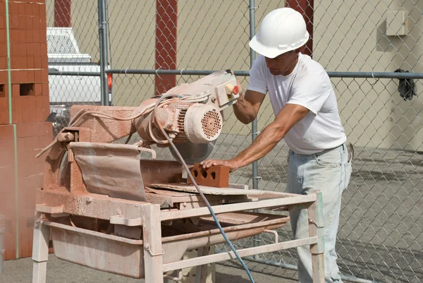 Arbeiter sägen Ziegel — Stockfoto